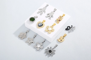 Detail of assorted flower and heart pendants with zircon and pearl in gold and silver