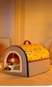 Detailed view of plush cat house with thickened white lining and hanging pom-pom toy