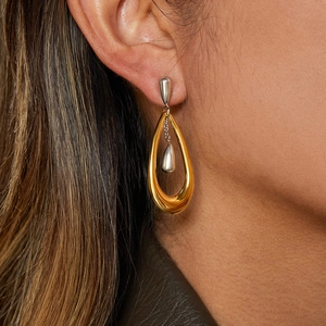 Two-tone water drop earrings in gold and silver finish worn by a fashion model