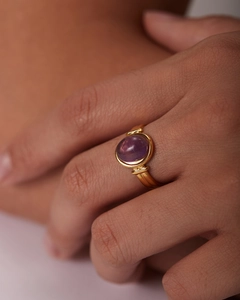 Dettaglio dell'anello in oro 18K con pietra preziosa ovale viola incastonata