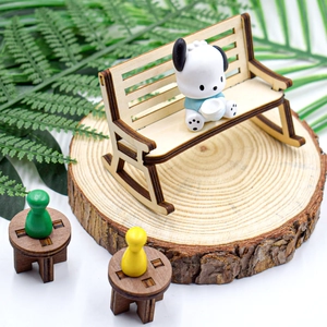 Miniature wooden laser-cut dollhouse furniture set with a rocking bench and round tables