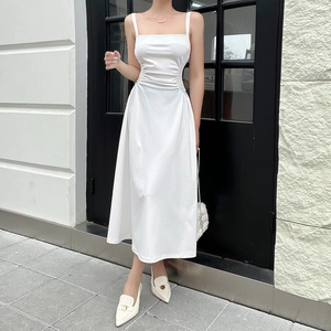 Close-up of gathered waist folds and high-quality fabric on white A-line dress