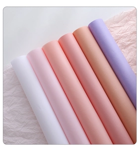 Detailed view of six gradient colored tissue paper rolls for floral and gift wrapping
