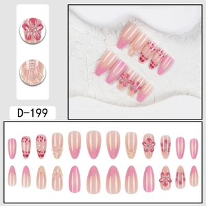 Detail of pink almond press-on nails with 3D floral relief, pearls, and D-199 markings