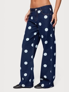 Women's dark blue wide-leg denim jeans featuring large white polka dots and a retro style