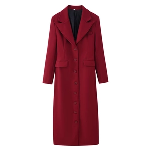 Detailed view of dark red wool coat with lapel collar, buttons and side flap pockets