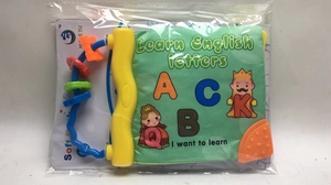 Detail of infant cloth book featuring yellow handle with colorful sensory beads