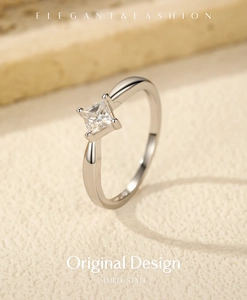 Detailed view of square princess cut moissanite ring set in a four-prong silver band