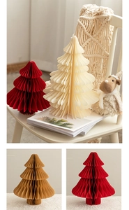 Close-up of honeycomb paper Christmas tree decor in red, ivory, and brown colors