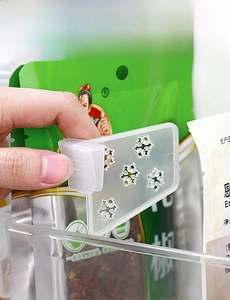 Detail of adjustable refrigerator divider clip with snowflake holes for side door storage