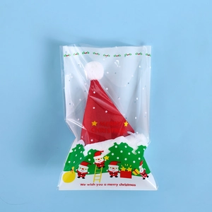 Detail of red Christmas hat for pets in clear holiday packaging with Santa motifs