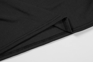 Detailed macro view of black ribbed knit fabric and flat double-needle hem stitching