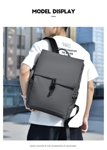 Outdoor view of a dark grey business backpack showing large capacity and matte leather