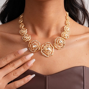 Luxurious gold hollow rose necklace with sparkling rhinestones worn by a model