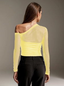 Rear view of yellow mesh long-sleeve top with sheer fabric and asymmetrical shoulder