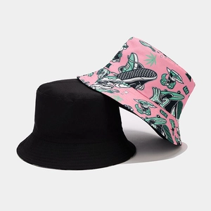 Detail showing reversible bucket hat with black solid side and trendy pink graphic print
