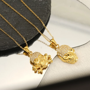 Détail du pendentif tête de mort hip hop avec finition dorée et pierres de zircone