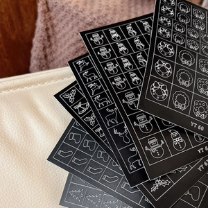 Christmas nail art stickers featuring white deer, snowmen, and tree motifs on black
