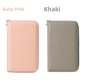 Close-up of pebble grain leather RFID passport wallets in baby pink and khaki with zippers