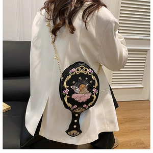 Mirror-shaped black crossbody bag featuring angel embroidery and golden chain detail