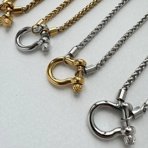 Macro shot of 18K gold and silver stainless steel keel chains with U-clasp details
