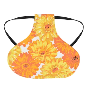 Detail of sunflower print poultry saddle with black elastic straps on white background