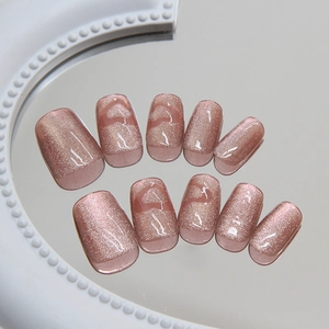 Short square rose gold cat eye press-on nails with hollow heart designs on mirror tray