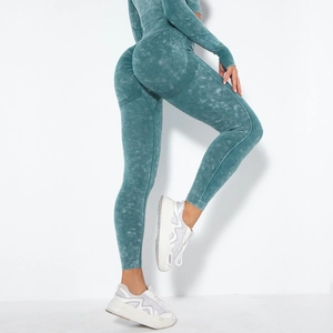 Detail of high-waisted seamless yoga pants with peach lift effect and ribbed texture