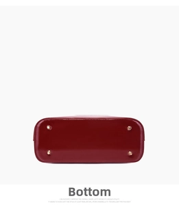 Detail of red patent leather handbag base with gold-tone protective metal feet