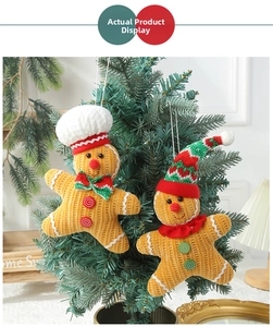 Close-up of two gingerbread doll ornaments with chef and knit hats hanging on a Christmas tree
