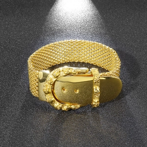 Detailed macro view of gold-plated snake bone mesh bracelet with gothic skull buckle