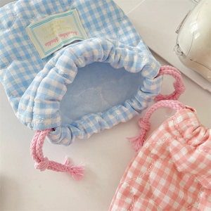 Detail of quilted heart pattern and woven drawstring on soft cotton storage pouches