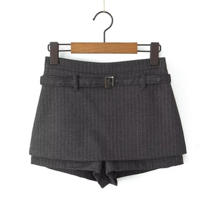 Detail of dark grey striped skort featuring a layered hem and matching buckled belt
