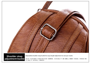 Detail view of brown leather bag showing vintage texture and silver metal adjustment buckle