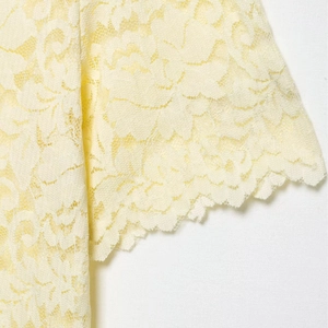Short sleeve lace polo shirt for women in yellow featuring delicate floral patterns