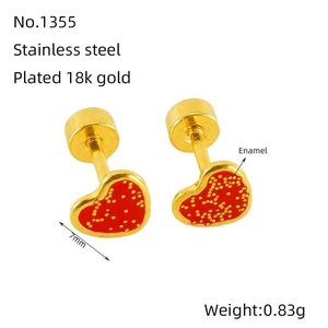 Detailed view of heart-shaped stainless steel earrings with red enamel and golden dots
