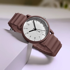 Detail of minimalist chocolate silicone watch strap with unique wavy texture and white dial