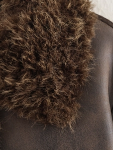 Detail shot of brown thick leather and soft plush fur lining on a winter coat