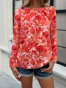 Detail of long sleeve top featuring red rose floral print and classic round neckline
