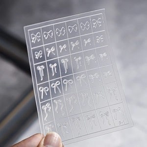 Detail of transparent nail art sticker featuring white bow designs and model F-1 code