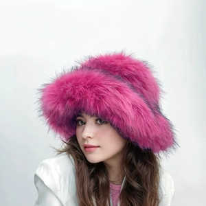 Close-up of fluffy faux fur winter hat in vibrant rose red with soft plush texture