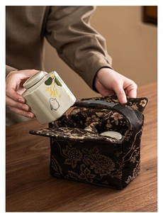 Close-up of portable rabbit pattern ceramic tea jar being placed in a padded fabric bag