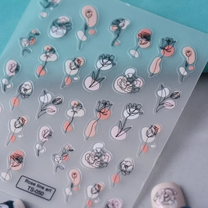 Close-up of TS-050 3D nail stickers featuring minimalist rose line art and abstract pink shapes
