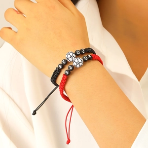 Detail of hand-woven 2026 soccer bracelets with adjustable cords and ceramic football beads