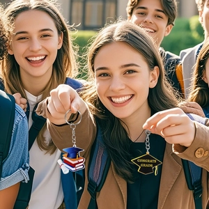 2026 graduation keychain featuring acrylic black and gold mortarboard and diploma pendants