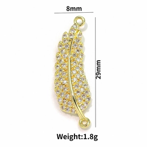 Macro view of 18k gold plated leaf pendant with zircons showing 8mm by 29mm dimensions