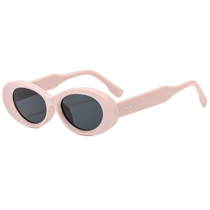 Chic oval pink sunglasses with dark grey lenses and diamond rivets in retro hip-hop style