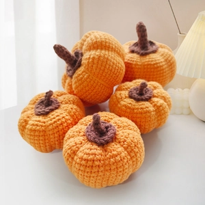 Set of five handmade crochet orange pumpkins for autumn home decor and Halloween props