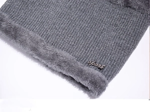 Macro view of grey knitted neck warmer with plush fleece lining and sport badge