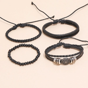 Detail of 4pcs black braided leather and beaded bracelet set with silver gear ornaments